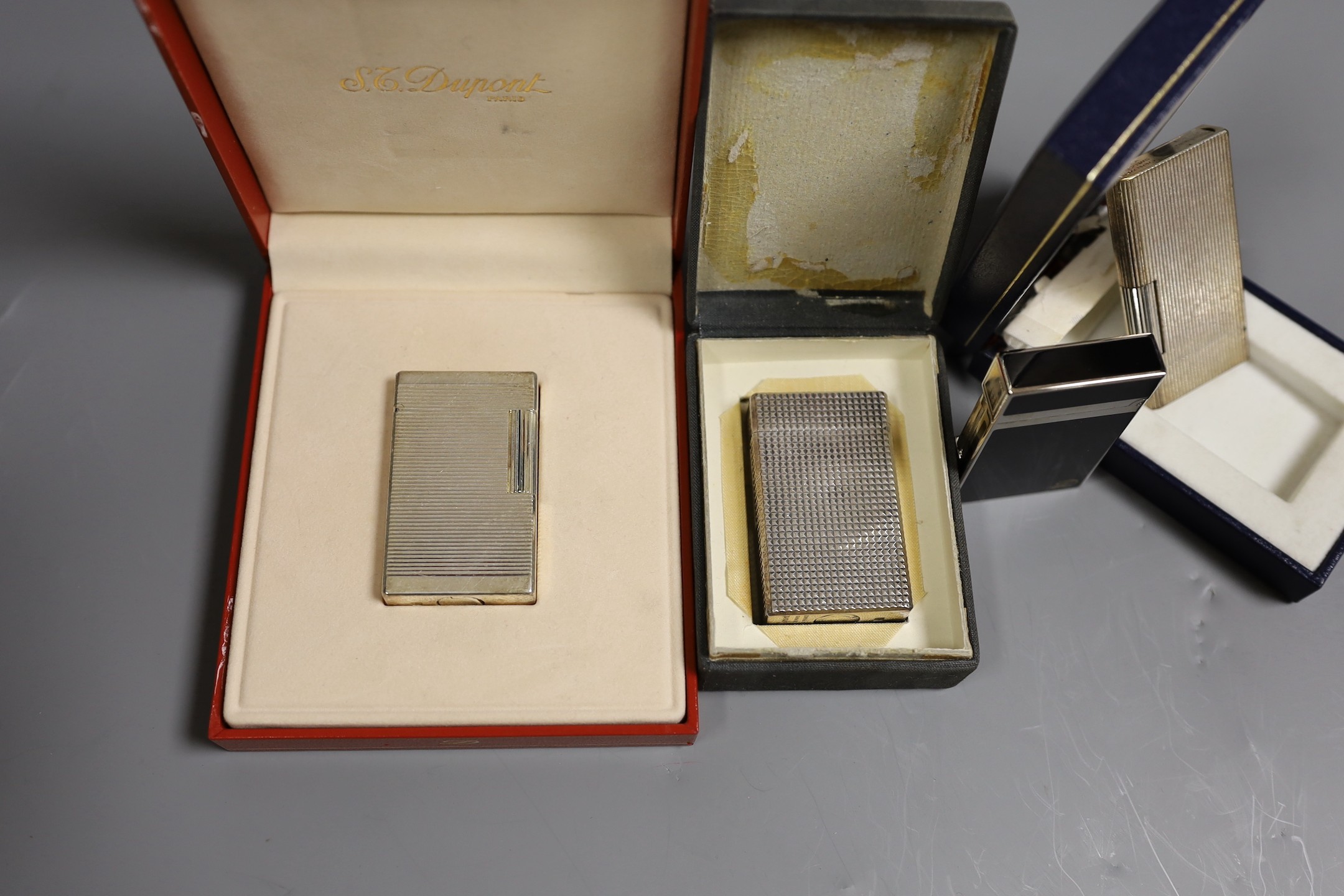 Four lighters including three by Dupont